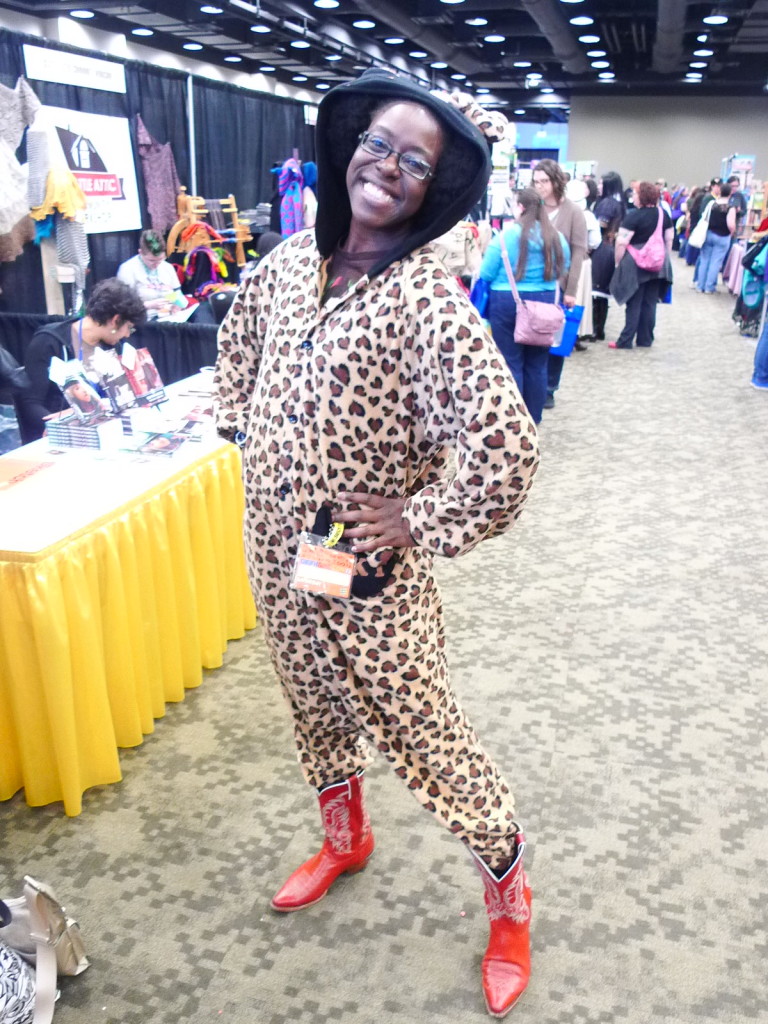 Lola LeSoleil wearing an adorable cheeta print hooded jumpsuit and red cowboy boots